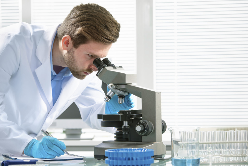 Scientist looking through a microscope in a laboratory